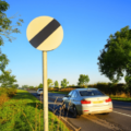 Understanding the White Circular Sign with a Black Diagonal Stripe: National Speed Limit Explained